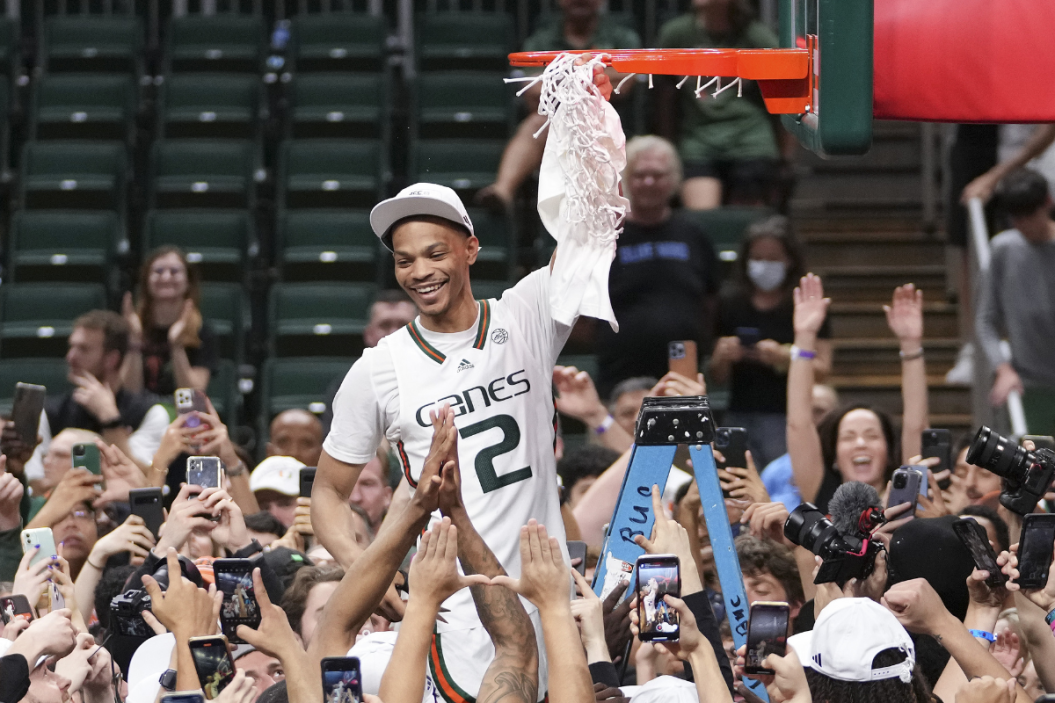 Isaiah Wong #2 of the Miami (Fl) Hurricanes cuts down the net after defeating the Pittsburgh Panthers 78-76 to win a share of the ACC Championship at Watsco Cente