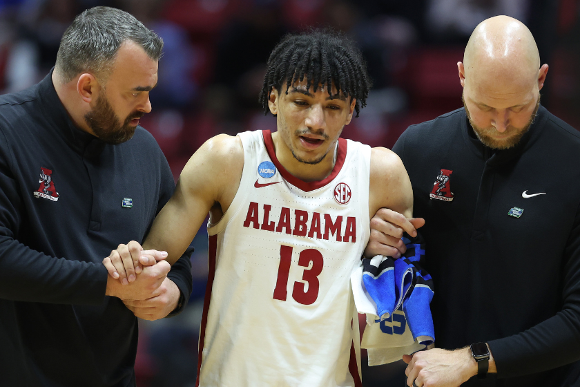 Jahvon Quinerly #13 of the Alabama Crimson Tide is helped off the court after being injured against the Notre Dame Fighting Irish during the first half in the first round game of the 2022 NCAA Men's Basketball Tournament at Viejas Arena at San Diego State University