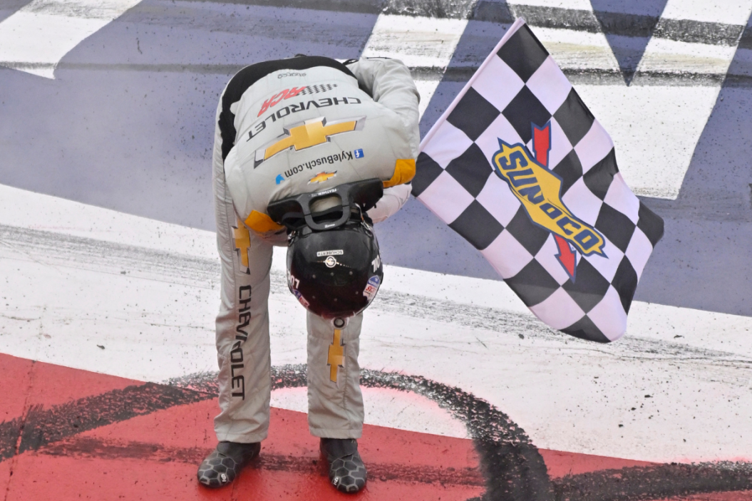 Kyle Busch takes a bow with the checkered flag after winning the 2023 Pala Casino 400 at Auto Club Speedway
