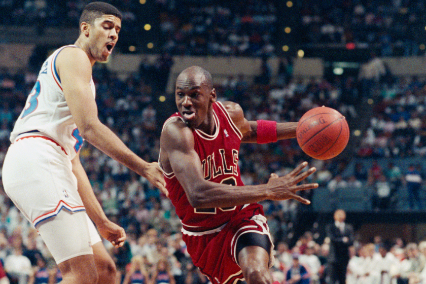 Michael Jordan works his way around Brad Daugherty and heads toward the basket during 1990 game at Coliseum