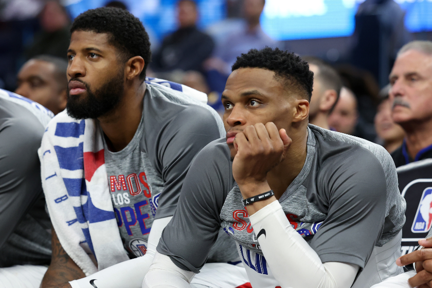 Russell Westbrook #0 and Paul George #13 of the LA Clippers sit on the bench during their game against the Golden State Warriors at Chase Center 