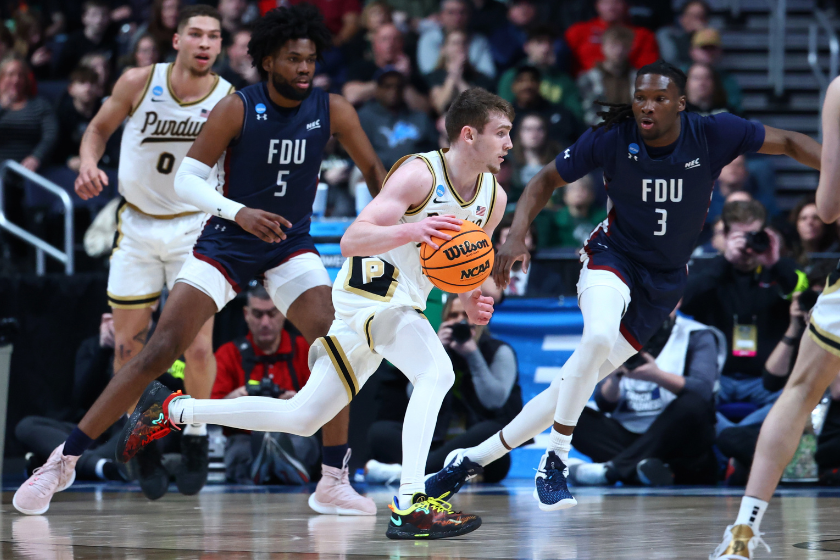 Braden Smith #3 of the Purdue Boilermakers dribbles between Ansley Almonor #5 and Heru Bligen #3 of the Fairleigh Dickinson Knights during the first round of the 2023 NCAA Men's Basketball Tournament held at Nationwide Arena