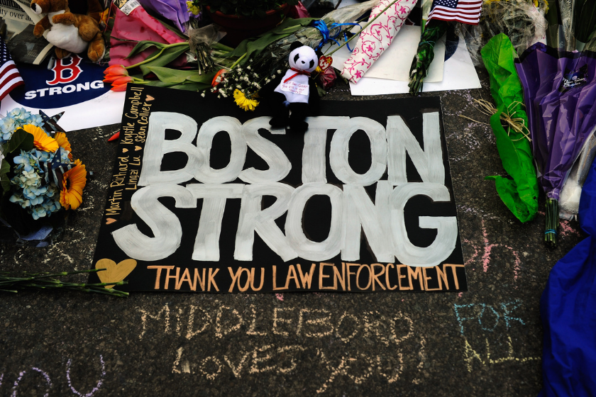 A large sign with the names of the Boston Marathon bombing victims and thanking law enforcement is placed by a Boston Bruins hockey team fan at a makeshift memorial for victims near the site of the bombings at the intersection of Boylston Street
