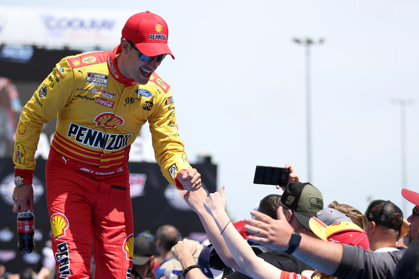 Joey Logano signs autographs for fans prior to the 2023 GEICO 500 at Talladega Superspeedway