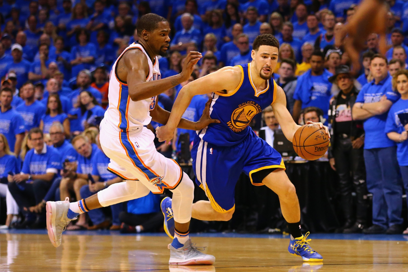 Klay Thompson #11 of the Golden State Warriors drives against Kevin Durant #35 of the Oklahoma City Thunder during the fourth quarter in game six of the Western Conference Finals during the 2016 NBA Playoffs