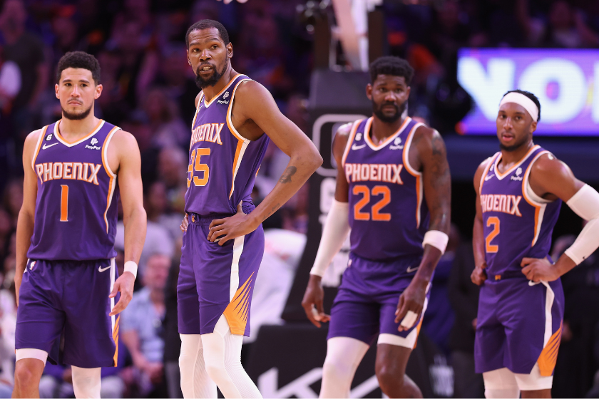 Devin Booker #1, Kevin Durant #35, Deandre Ayton #22 and Josh Okogie #2 of the Phoenix Suns stand on the court during a timeout from the second half of the NBA game against the Minnesota Timberwolves at Footprint Center