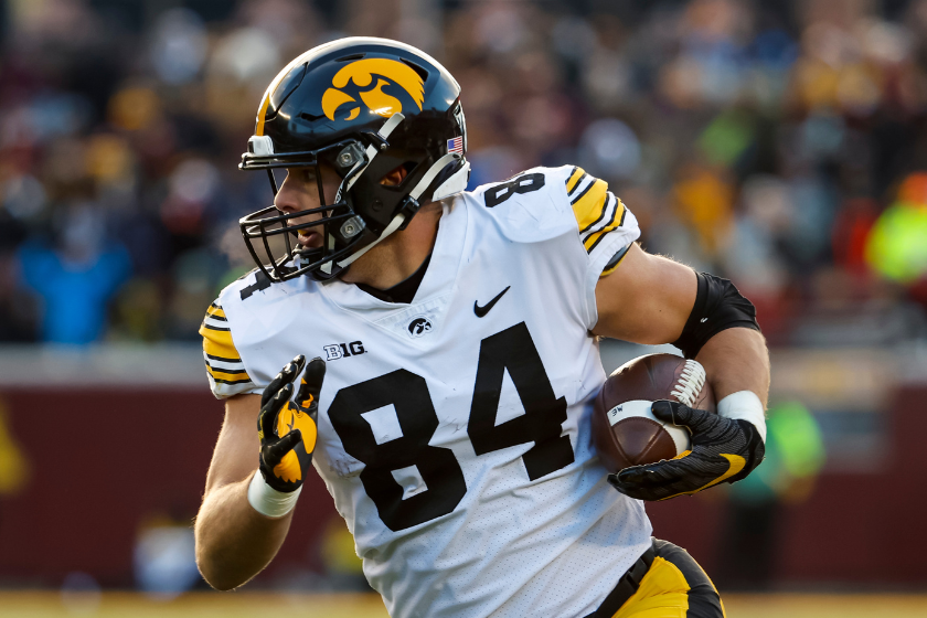 Sam LaPorta #84 of the Iowa Hawkeyes runs with the ball against the Minnesota Golden Gophers in the first quarter of the game at Huntington Bank Stadium