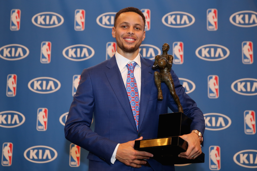 Stephen Curry of the Golden State Warriors poses with his NBA Most Valuable Player Award following a press conference at ORACLE Arena