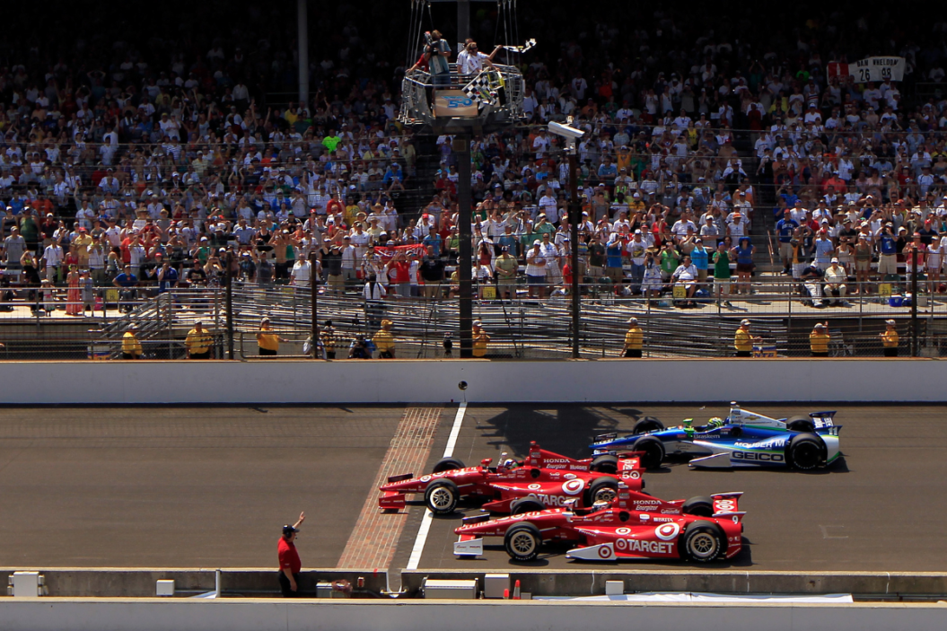 Dario Franchitti crosses the yard of bricks startfinish line to take the checkered flag ahead of teammate Scott Dixon and Tony Kannan to give Franchitti the win in the 2012 Indy 500