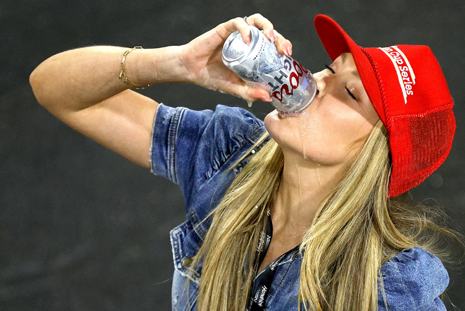 Katelyn Larson celebrates her husband Kyle Larson's win with a beer after the 2023 All-Star Race at North Wilkesboro Speedway