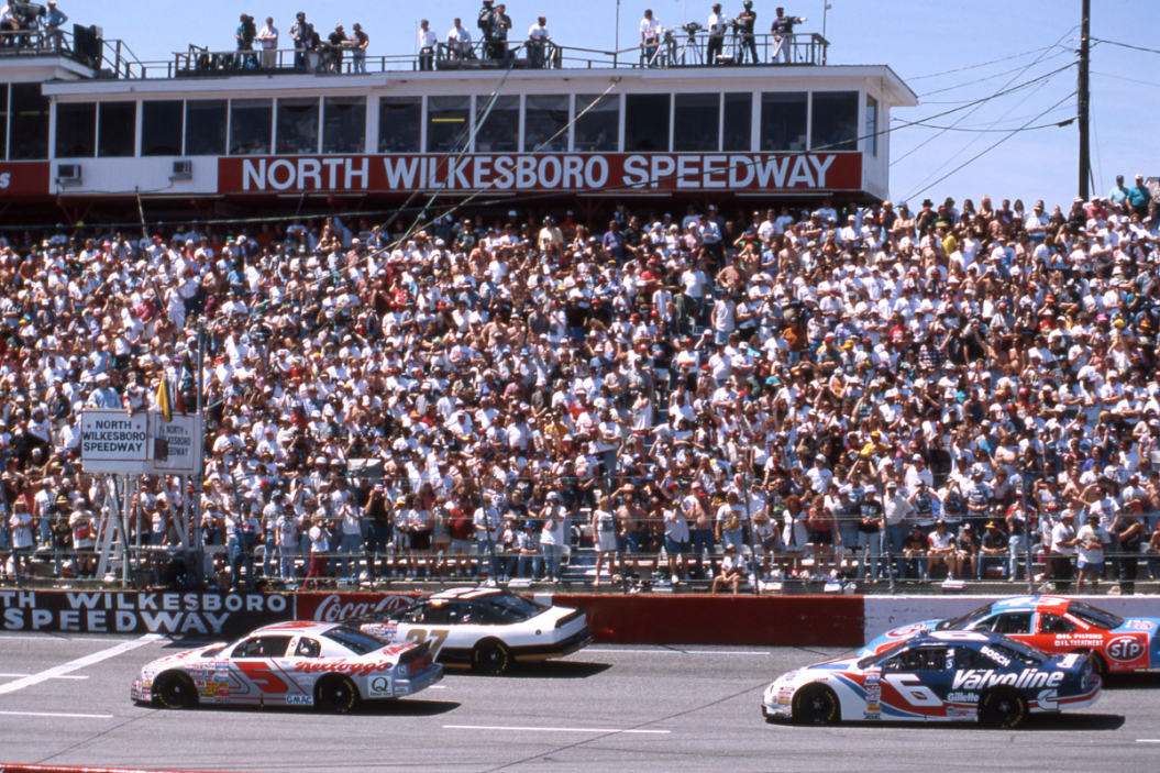 Terry Labonte (No 5) and Elton Sawyer (No 27) bring the field to the start of the 1996 First Union 400 at North Wilkesboro Speedway. Mark Martin is in No. 6 and the No. 43 is Bobby Hamilton.