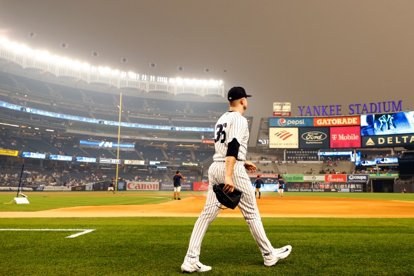 A Yankee player walks on to the field at Yankee Stadium.