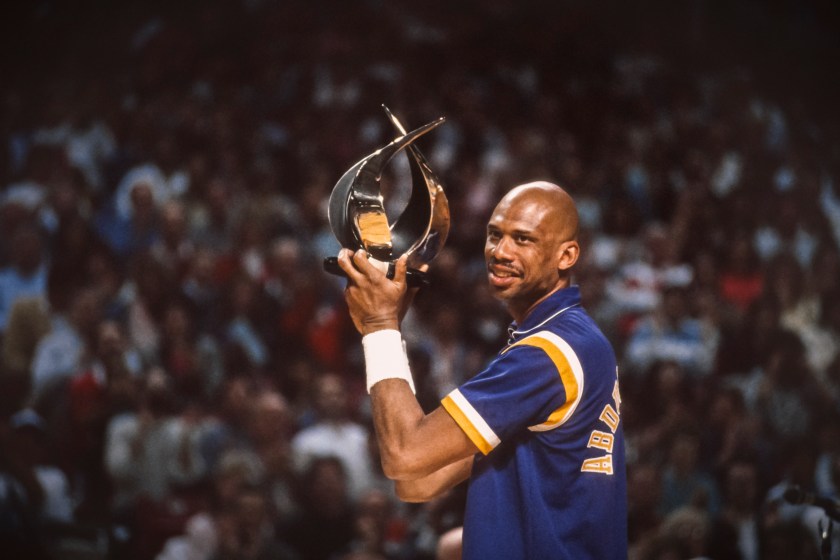 Kareem Abdul-Jabbar holds a trophy with the Lakers.