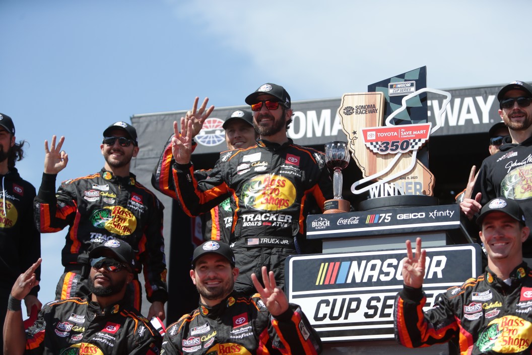 SONOMA, CA - JUNE 11: Martin Truex, Jr (#19 Joe Gibbs Racing Bass Pro Shops Toyota) poses for a photo with his team and celebrates winning the NASCAR Cup Series Toyota/Save Mart 350 on Sunday June 11, 2023, at Sonoma Raceway in Sonoma, CA.