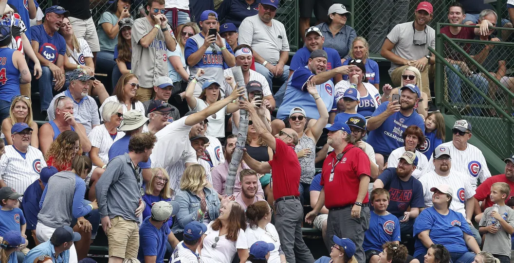 Wrigley Field security breaks up a beer snake during a Chicago Cubs game.