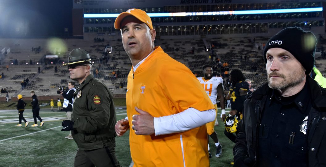 Former Tennessee Volunteers head coach Jeremy Pruitt is guarded by security after a game.