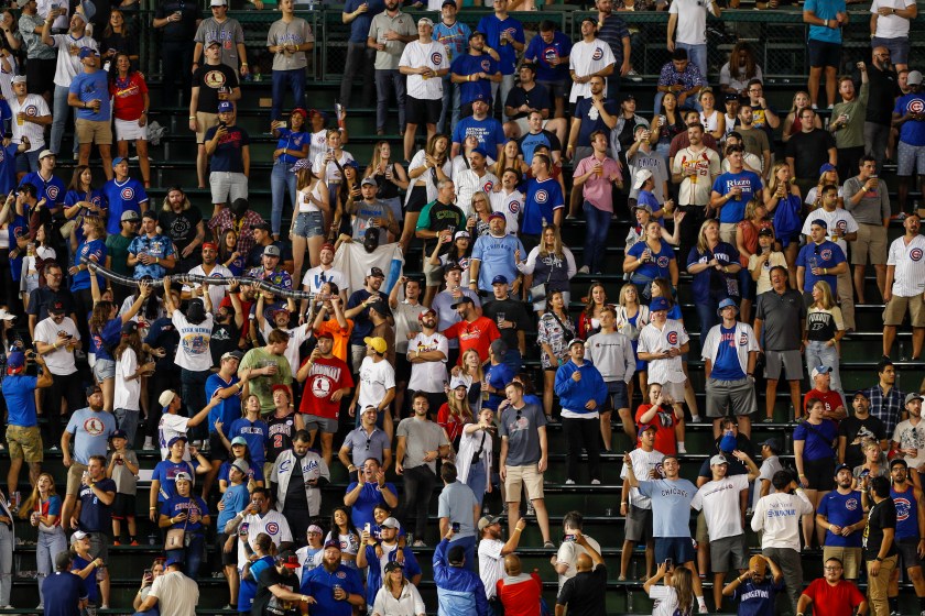 Chicago Cubs fans build a beer snake at Wrigley Field.