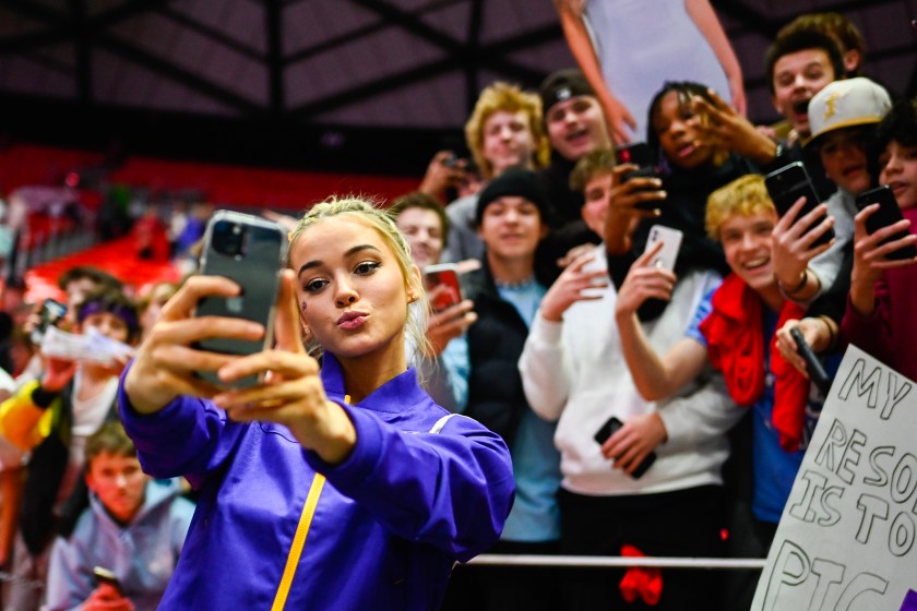 LSU gymnast Olivia Dunne takes a selfie with fans.