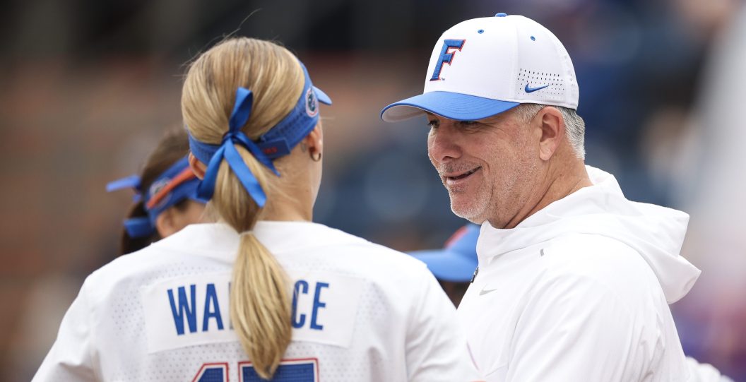 Florida softball head coach Tim Walton talks to a player.
