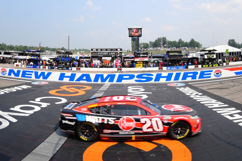 Cars cross the finish line at NASCAR's Crayon 301 in New Hampshire
