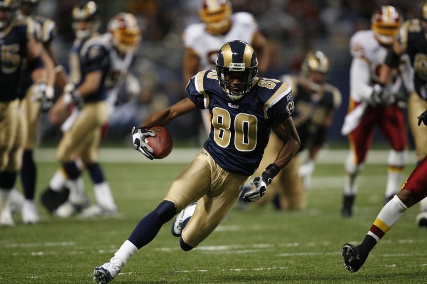 Former St. Louis Rams wide receiver Isaac Bruce runs after the catch.