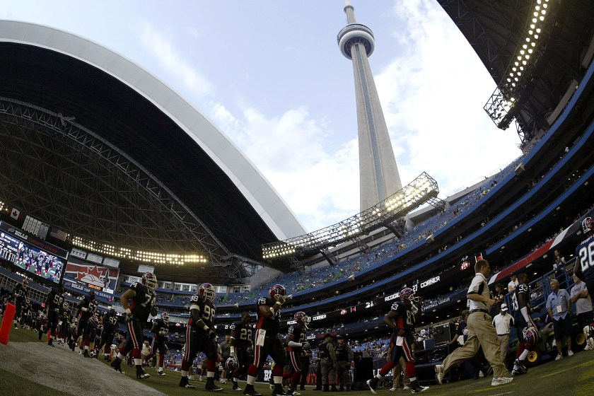 NFL players leave the field after warming up in Toronto.