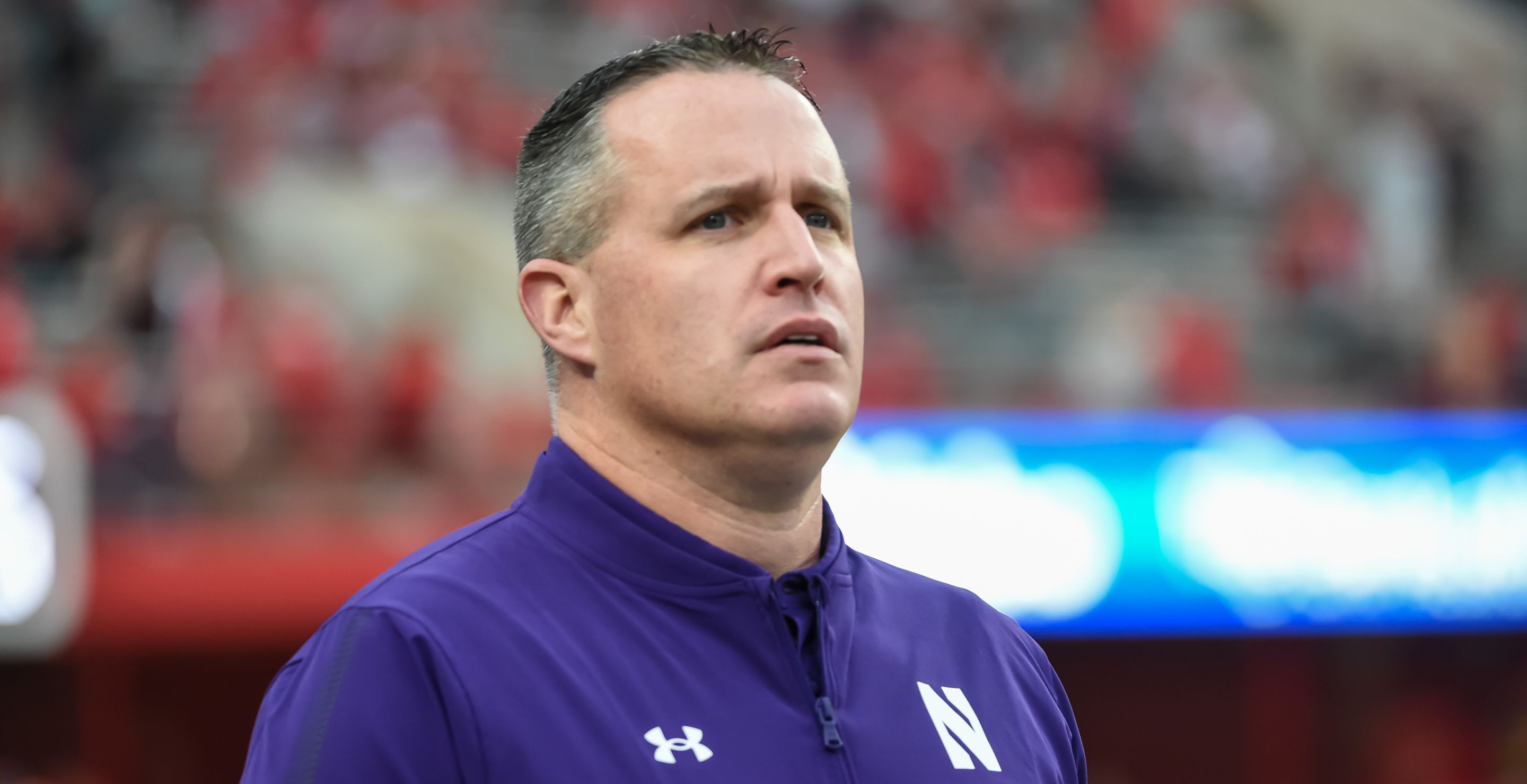 Pat Fitzgerald looks on while coaching for Northwestern.