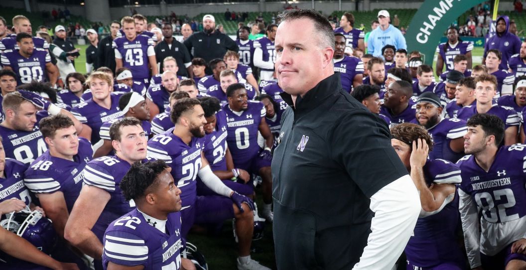 Pat Fitzgerald stands in front of his Northwestern football team.