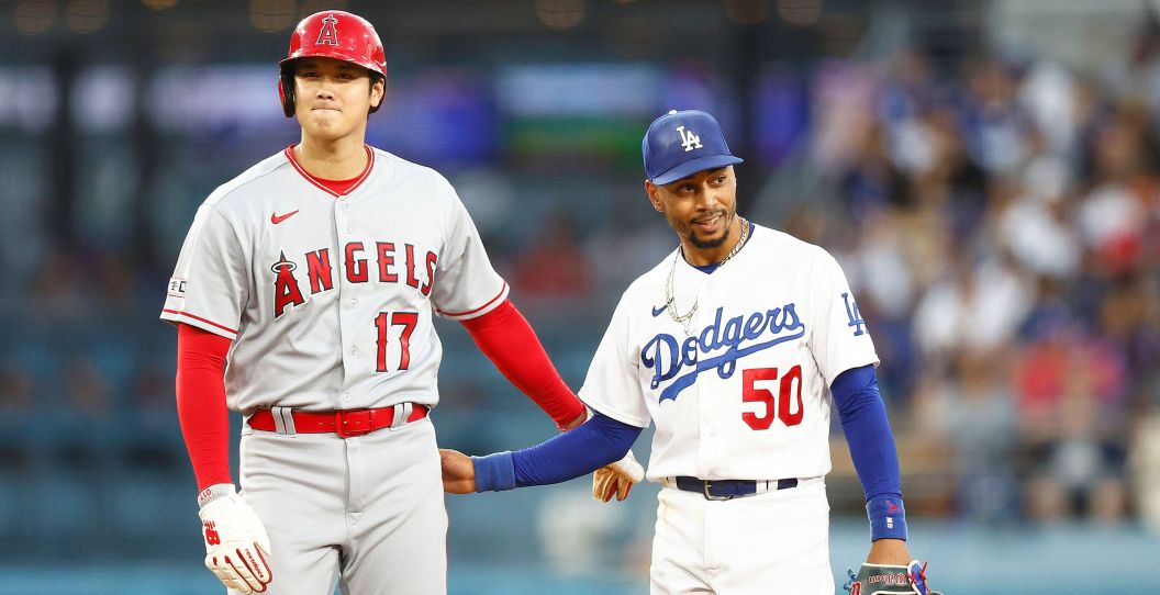 Shohei Ohtani greets Dodgers' Mookie Betts on the field.