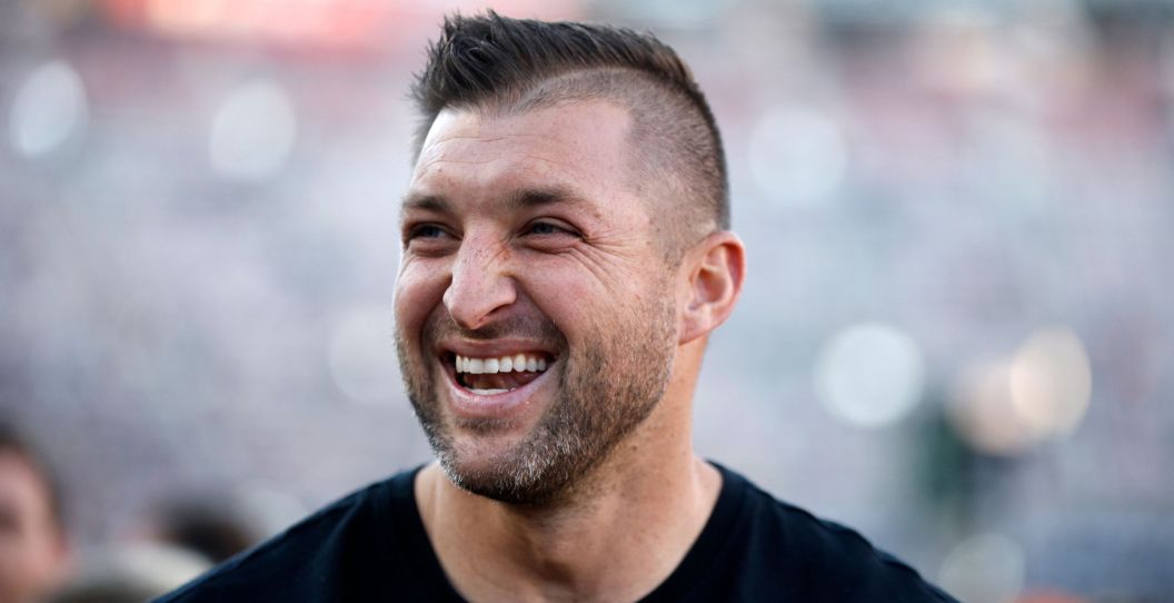 Tim Tebow smiles at the NASCAR Cup Series Food City Dirt Race at Bristol Motor Speedway