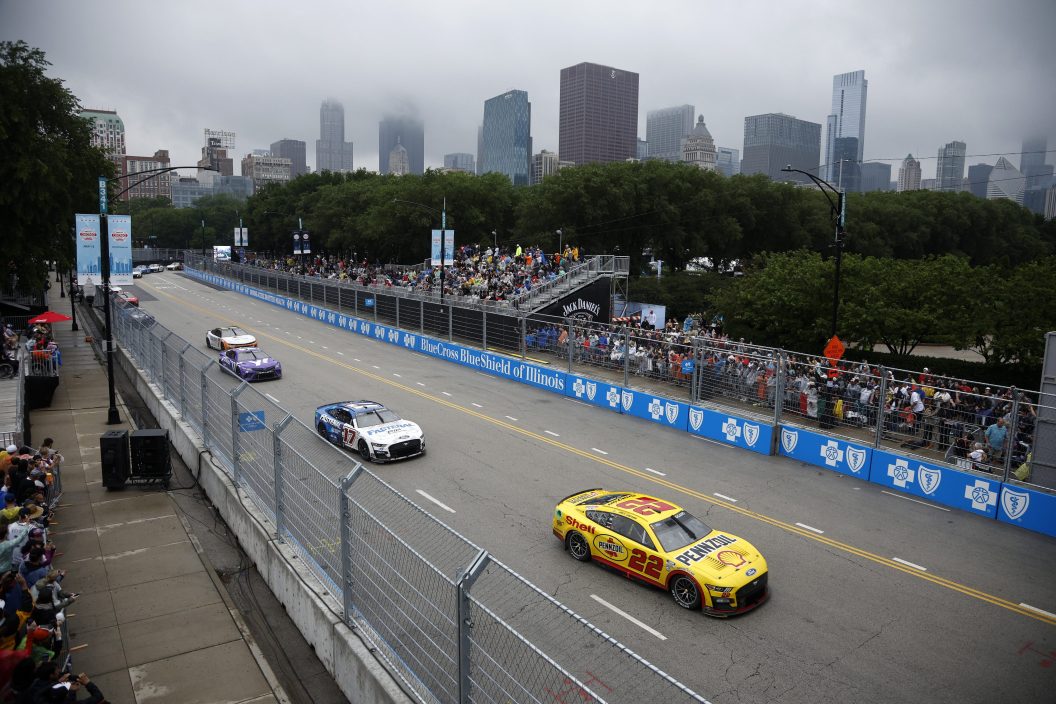 CHICAGO, ILLINOIS - JULY 02: Joey Logano, driver of the #22 Shell Pennzoil Ford, and Chris Buescher, driver of the #17 Fastenal Ford, race during the NASCAR Cup Series Grant Park 220 at the Chicago Street Course on July 02, 2023 in Chicago, Illinois.