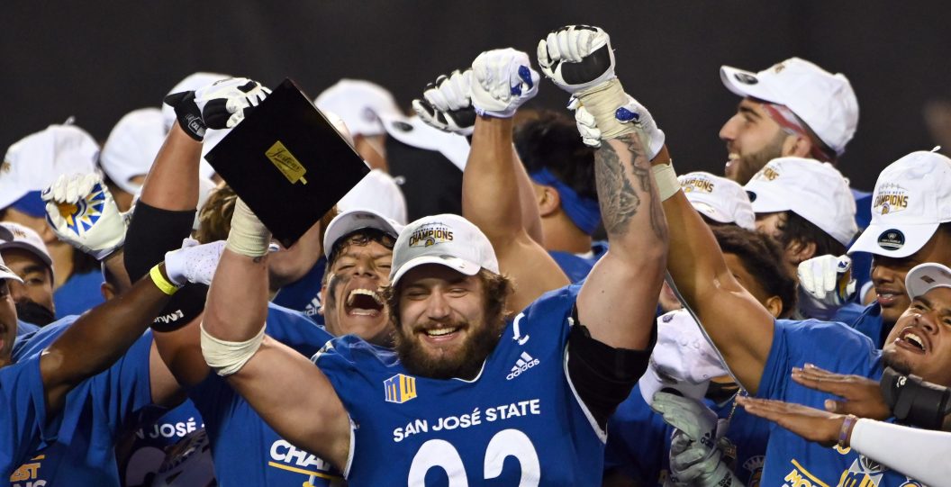 LAS VEGAS, NEVADA - DECEMBER 19: Defensive lineman Cade Hall #92 of the San Jose State Spartans raises the Mountain West Championship game defensive MVP trophy after the team defeated the Boise State Broncos 34-20 in the Mountain West Football Championship at Sam Boyd Stadium on December 19, 2020 in Las Vegas, Nevada.
