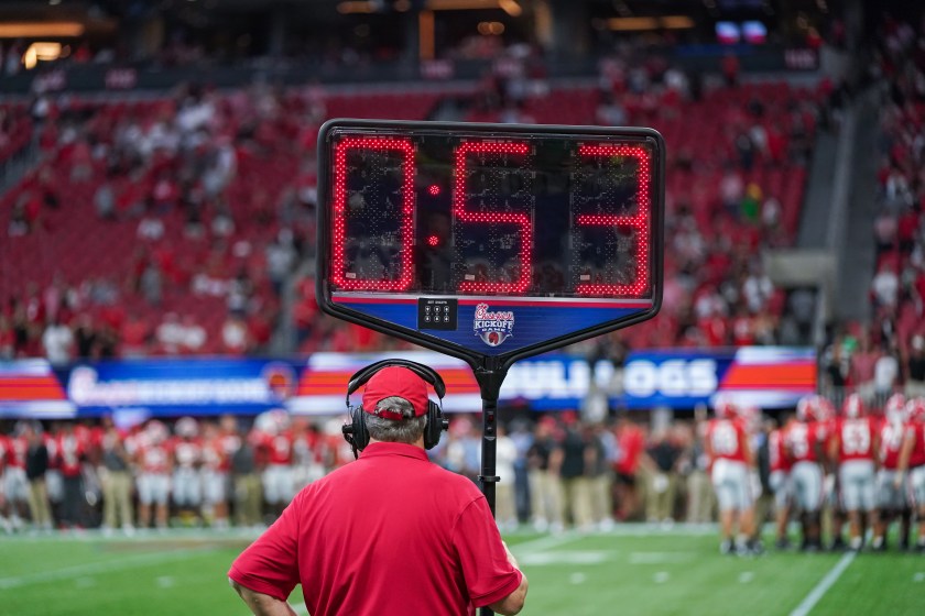 A clock is shown in a college football game.