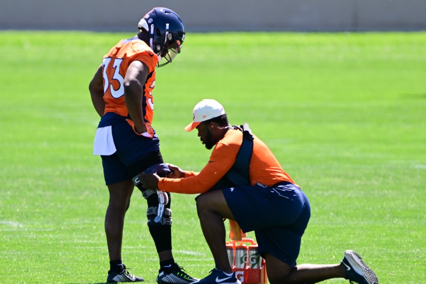 Javonte Williams has his knee checked out during Broncos practice.