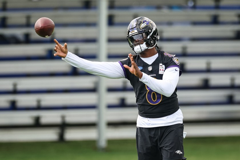 OWINGS MILLS, MD - JULY 27: Lamar Jackson #8 of the Baltimore Ravens attempts a pass during training camp at Under Armour Performance Center Baltimore Ravens on July 27, 2023 in Owings Mills, Maryland. 