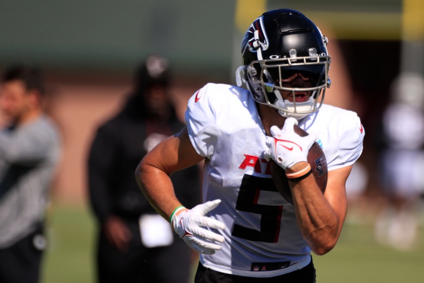 FLOWERY BRANCH, GA - AUGUST 05: Atlanta Falcons wide receiver Drake London #5 runs with the football during Atlanta Falcons training camp on August 5, 2023 at IBM Performance Field in Flowery Branch, GA.(