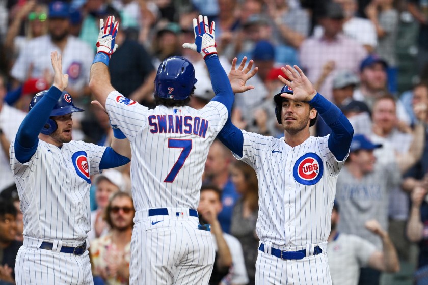 Cubs celebrate hitting home runs off of Reds pitcher Ben Lively