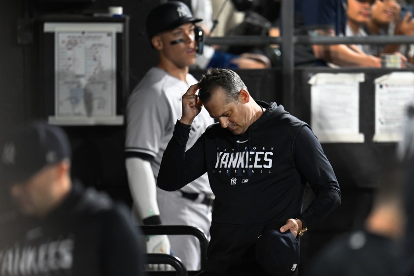 Aaron Boone walks into the dugout after being ejected.