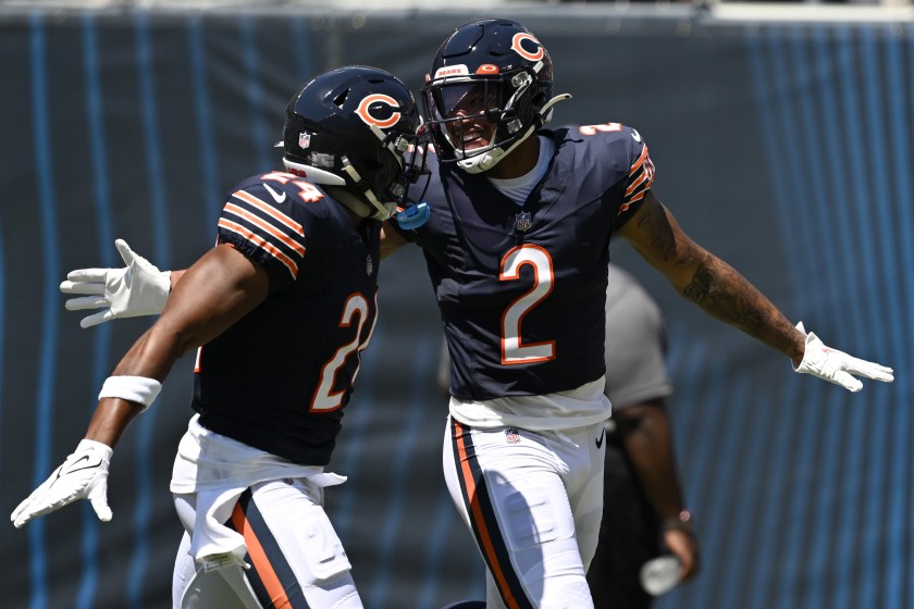 CHICAGO, ILLINOIS - AUGUST 12: Khalil Herbert #24 and DJ Moore #2 of the Chicago Bears celebrate after a touchdown in the first quarter against the Tennessee Titans during a preseason game at Soldier Field on August 12, 2023 in Chicago, Illinois. 