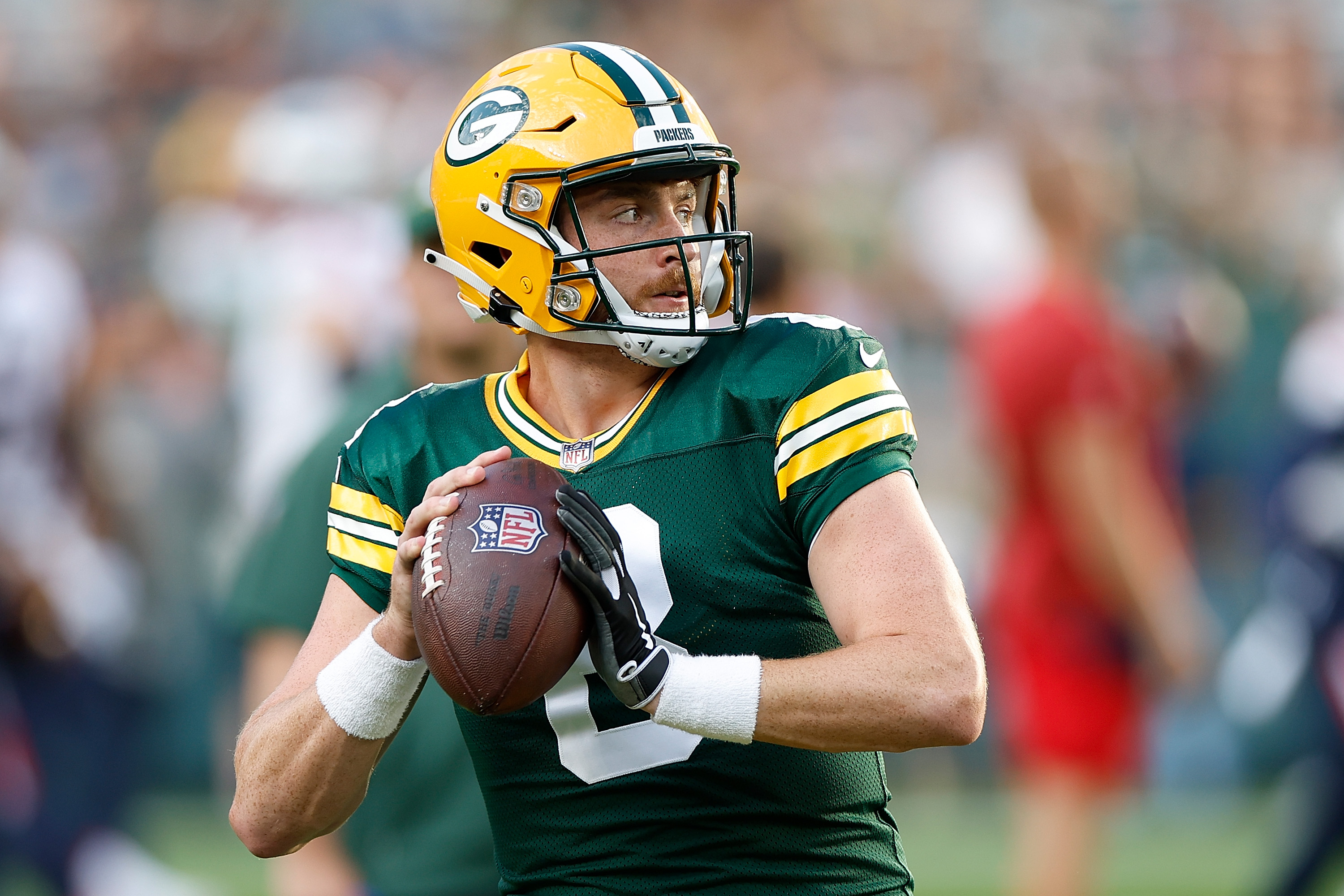 GREEN BAY, WISCONSIN - AUGUST 19: Sean Clifford #8 of the Green Bay Packers warms up before the preseason game against the New England Patriots at Lambeau Field on August 19, 2023 in Green Bay, Wisconsin. 