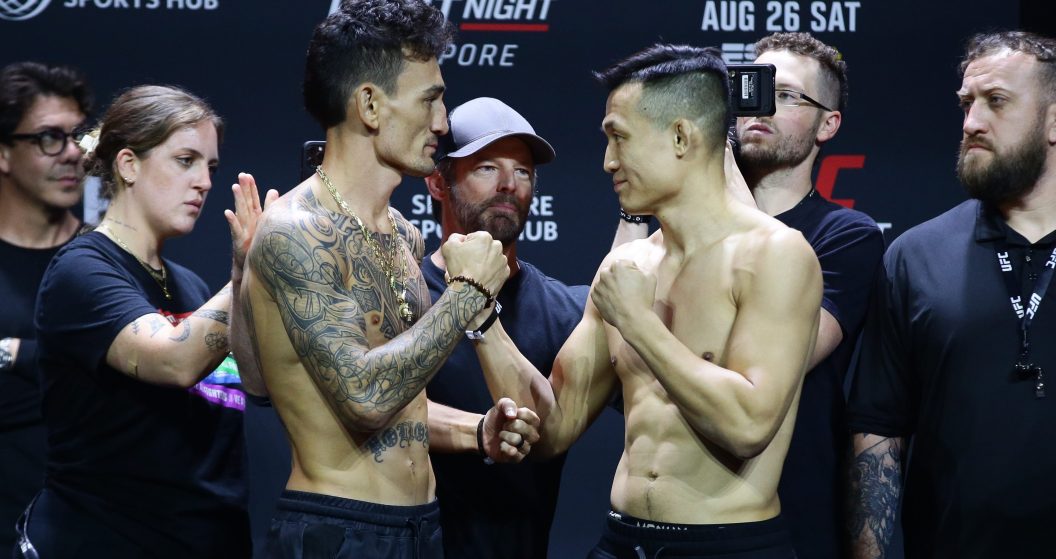 SINGAPORE, SINGAPORE - AUGUST 25: (L-R) Opponents Max Holloway and Chan Sung Jung of South Korea face off during the UFC Fight Night ceremonial weigh-in at Singapore Indoor Stadium on August 25, 2023 in Singapore.