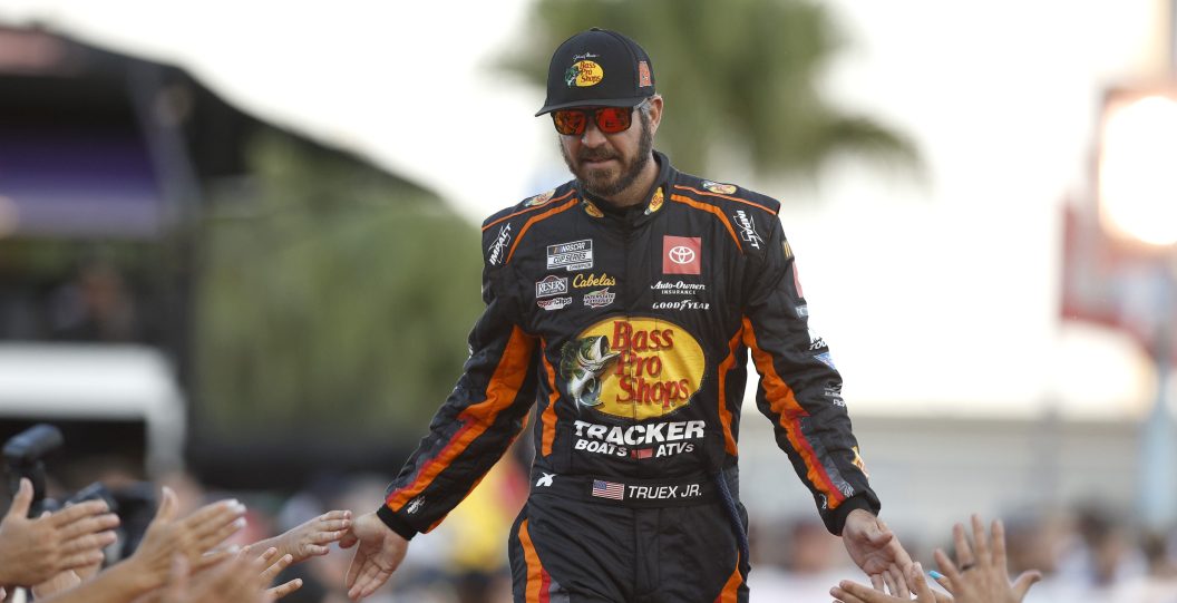 DAYTONA BEACH, FLORIDA - AUGUST 26: Martin Truex Jr., driver of the #19 Bass Pros Shops/Ducks Unlimited Toyota, greets fans as he walks onstage during driver intros prior to the NASCAR Cup Series Coke Zero Sugar 400 at Daytona International Speedway on August 26, 2023 in Daytona Beach, Florida.