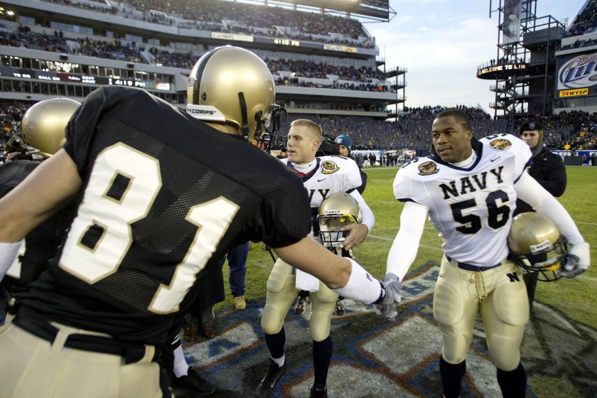 PHILADELPHIA - DECEMBER 6:  Eddie Carthan #56 of the Navy shakes hands with Clint Woody #81 of the Army at the Lincoln Financial Field Stadium on December 6, 2003 in Philadelphia, Pennsylvania. The Navy defeated the Army 34-6.  