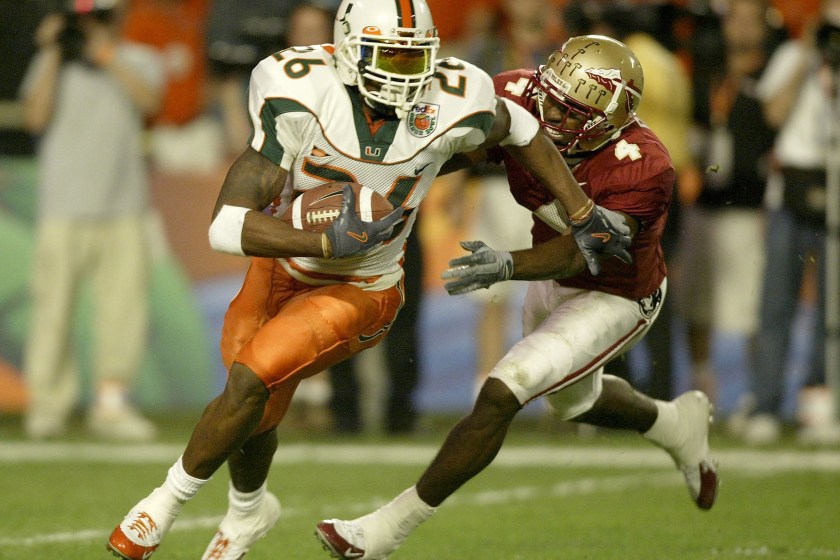 MIAMI - JANUARY 1:  Sean Taylor #26 of the Miami Hurricanes tries to elude P.K. Sam #4 of the Florida State Seminoles after making an interception during the Orange Bowl January 1, 2004 at Pro Player Stadium in Miami, Florida.  