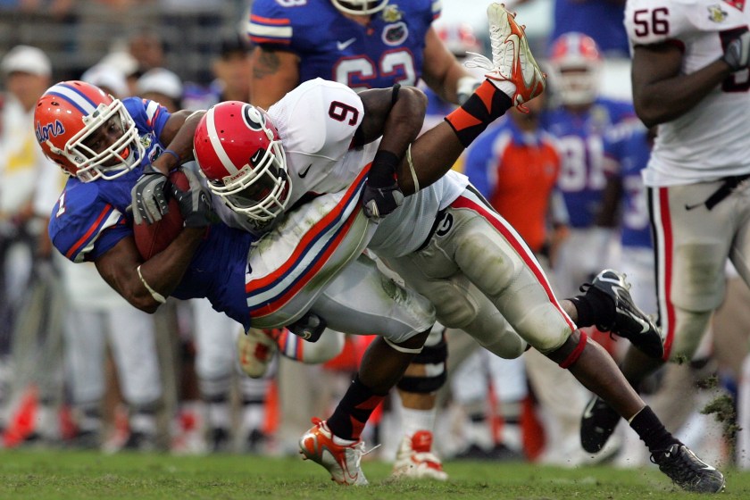 JACKSONVILLE, FL - OCTOBER 27:  Wide receiver Percy Harvin #1 of the Florida Gators is tackled by Reshad Jones #9 of the Georgia Bulldogs at Jacksonville Municipal Stadium on October 27, 2007 in Jacksonville, Florida.  
