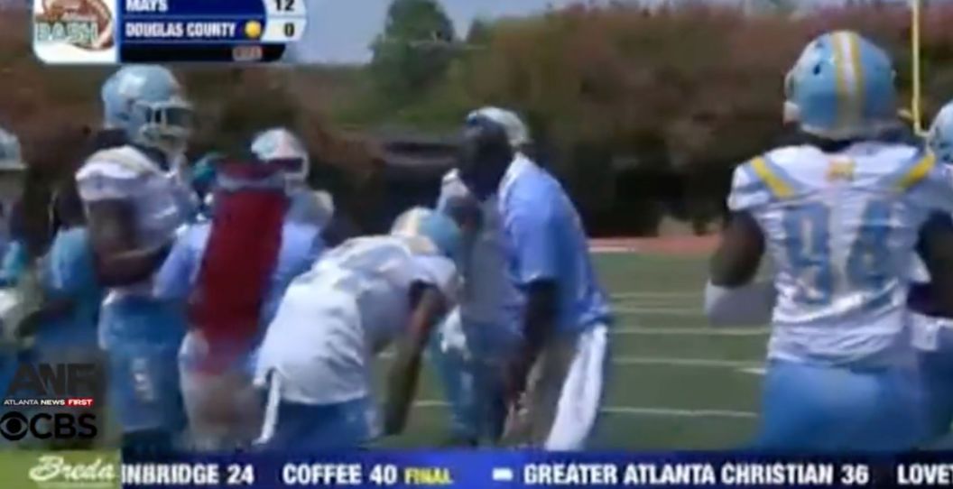 A high school coach punches a player.