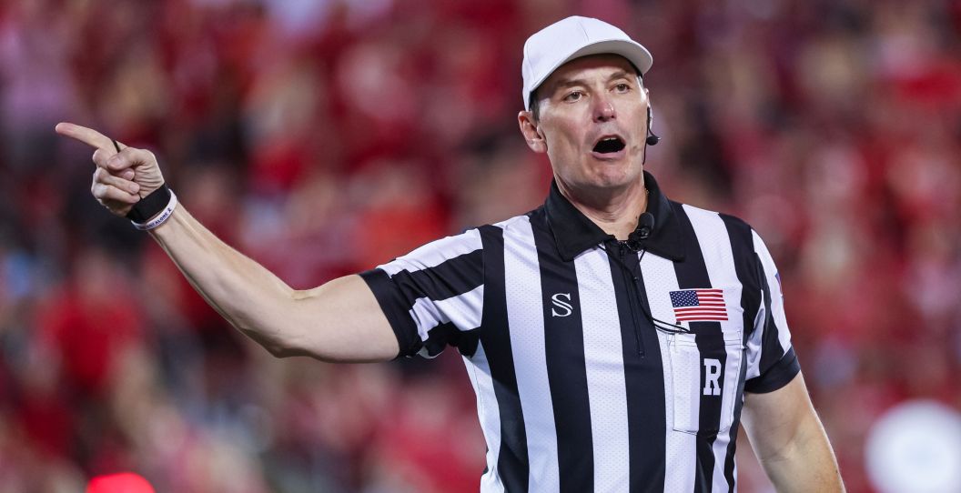A referee points his finger during a college football game.