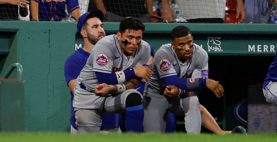 Mets players look on after a loss.