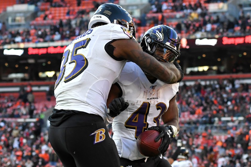CLEVELAND, OH - DECEMBER 22, 2019: Running backs Justice Hill #43 and Gus Edwards #35 of the Baltimore Ravens celebrate an 18-yard touchdown by Hill in the fourth quarter of a game against the Cleveland Browns on December 22, 2019 at FirstEnergy Stadium in Cleveland, Ohio. Baltimore won 31-15. 