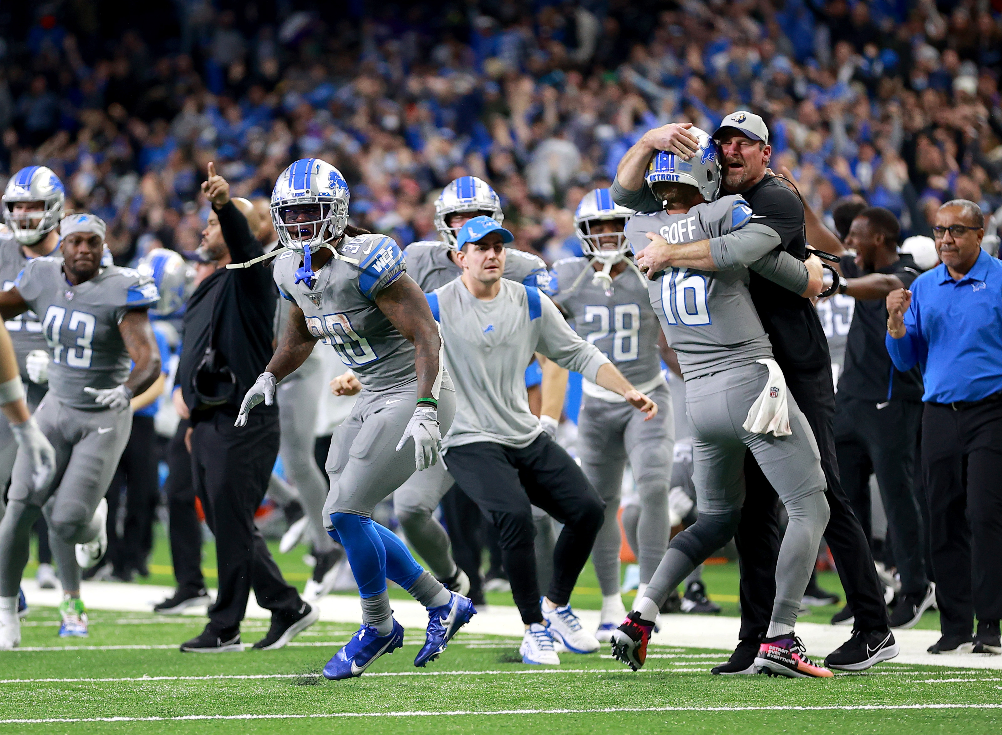 DETROIT, MICHIGAN - DECEMBER 05: Jared Goff #16 of the Detroit Lions celebrates with head coach Dan Campbell after defeating the Minnesota Vikings 29-27 to win their first game of the season at Ford Field on December 05, 2021 in Detroit, Michigan. 